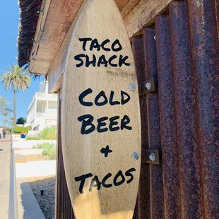 a sign for taco snack and cold beer tacos