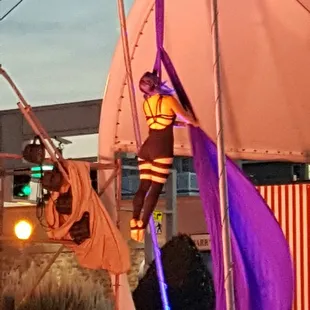 a circus performer on a pole