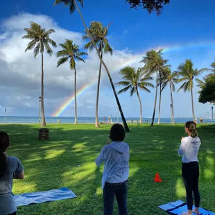 rainbow salutations at beach yoga in waikiki