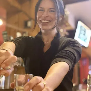 a woman pouring a glass of wine