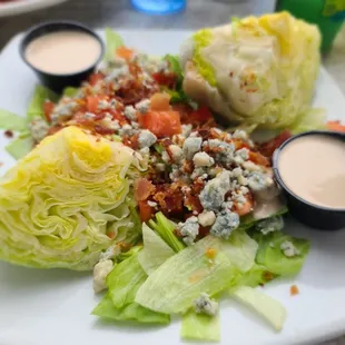 a plate of salad with lettuce and dressing