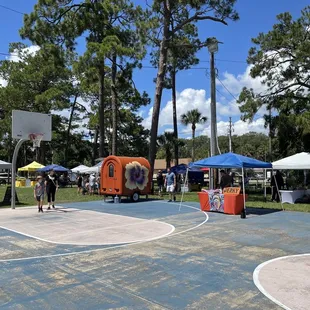 a basketball court surrounded by tents