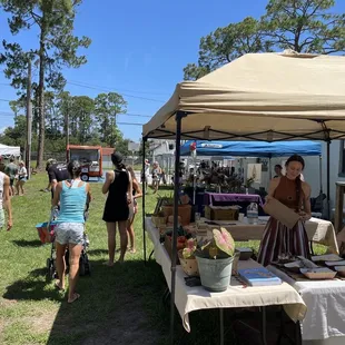 people walking around a tent
