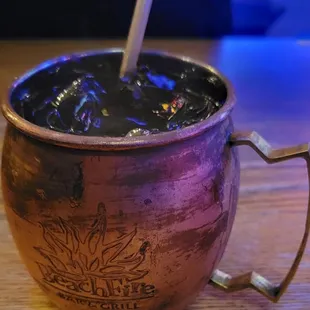 a copper mug with a spoon in it