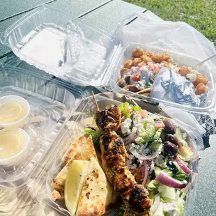 Lamb Gyro with Feta Tots, Greek Salad with house dressing and one Chicken Skewer served with pita.