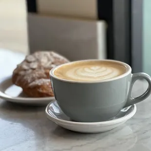 a cup of cappuccino and a plate of croissants
