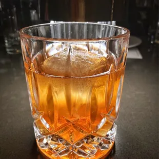 a glass of whiskey on a table