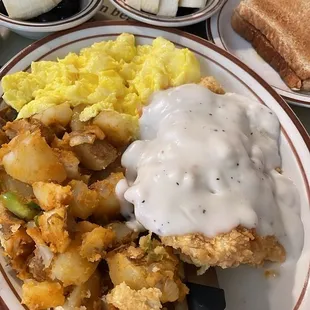 Country Fried Chicken (breakfast) with scrambled eggs and fried potatoes. Side of Fruit (blueberries and banana)