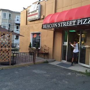 Outside, entrance and outdoor seating area.