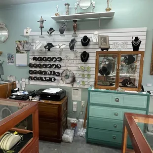 Wire wall and cases with pieces for jewelry.