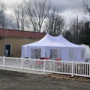 a white tent set up in a parking lot