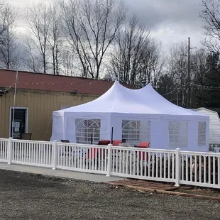 a white tent set up in a parking lot