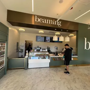 a woman standing in front of a store counter