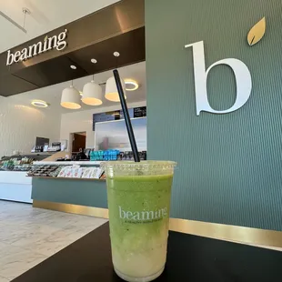 a green smoothie in a glass on a table