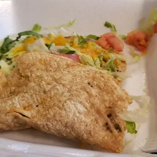 Taco that looks like it was dropped and a soggy tostada.