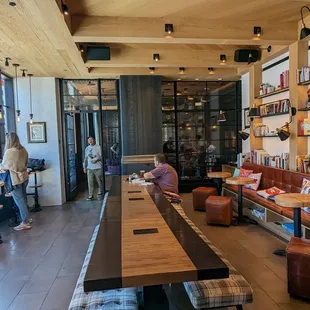 people sitting at tables in a coffee shop