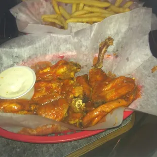 a basket of wings and fries