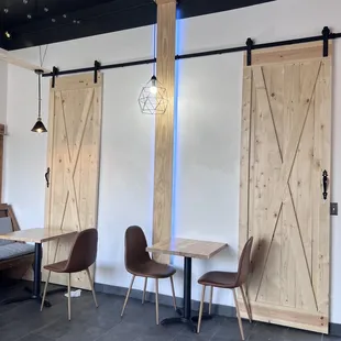 the interior of a restaurant with tables and chairs