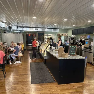 people sitting at tables in a restaurant