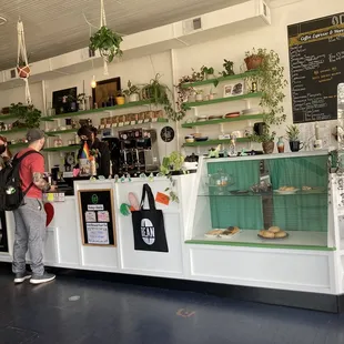 a man standing at a counter in a coffee shop