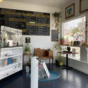a coffee shop with a menu on the wall