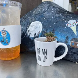 a cup of coffee and a rock