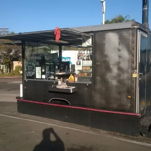 a street corner with a coffee stand