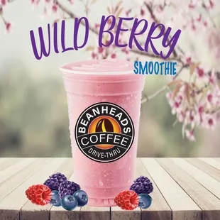a pink smoothie with berries on the table
