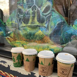 three coffee cups in front of a window