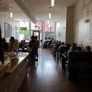 people sitting at tables in a restaurant