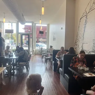 people sitting at tables in a restaurant