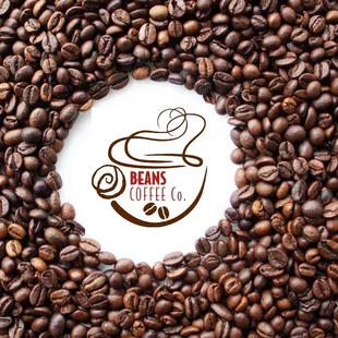 a cup of coffee surrounded by coffee beans