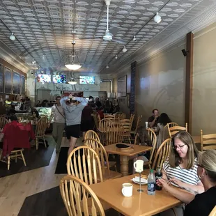 people sitting at tables and eating