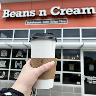  hand holding a cup of coffee