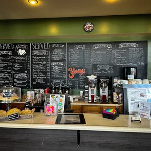 ows a coffee shop counter with a chalkboard
