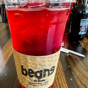 ows a red drink in a plastic cup