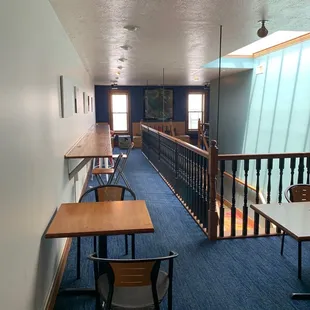 a long hallway with tables and chairs