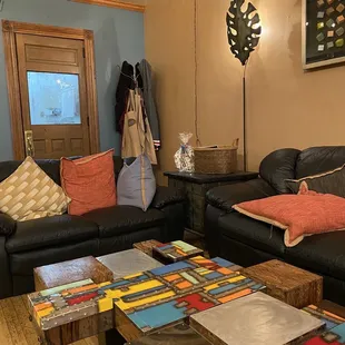 a living room with black leather couches