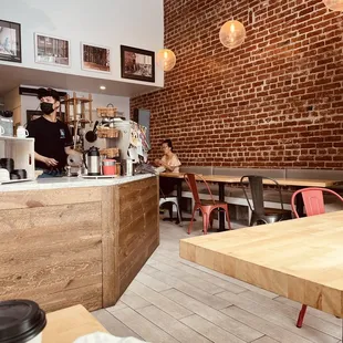 Cute &apos;n comfy w/plenty of seats for such a tiny cafe - love the brick wall.