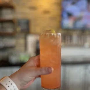 a person holding up a drink