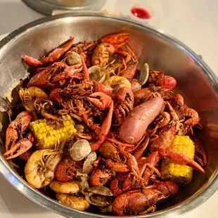 a bowl of crawfish and corn