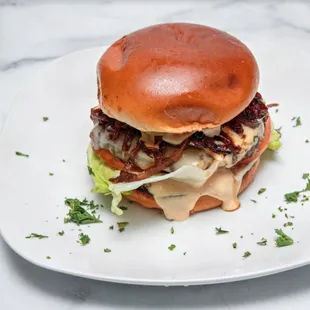 a bear burger on a white plate