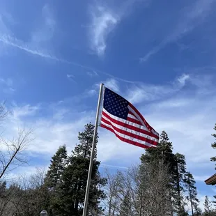 the american flag flying in the wind