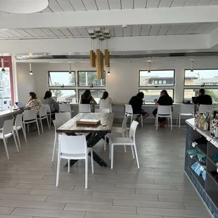 people sitting at tables in a cafe