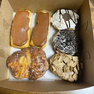 two Boston cream, Apple fritter, Oreo, Cinnamon Toast Crunch &amp; reeses donuts!