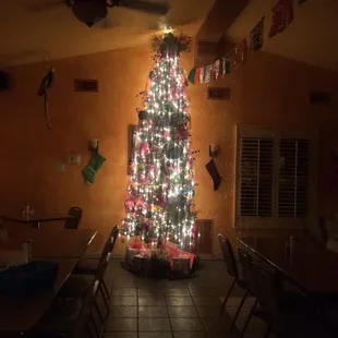 a decorated christmas tree in a dining room