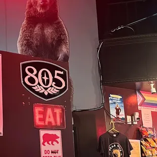 Decor, signs, merchandise, progress pride flag, inside.