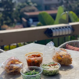 1 lb of salmon poke, 1/4 lb cucumber salad, 1/4 lb seaweed salad, and complimentary tortilla chips