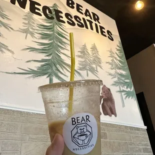 a hand holding a cup of iced coffee