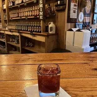 a glass of whiskey on a table